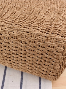 Detailed weave of minimalist straw tote bag with ribbon handle and natural brown texture