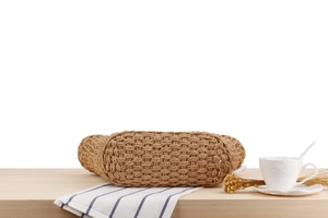 Detail of hand-woven straw bag showing intricate brown natural fiber texture and pattern