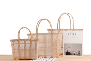 Three sizes of woven plastic storage baskets with transparent stripes and dual handles