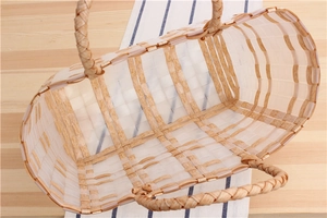 Macro detail of hand-woven plastic beach basket with wood texture and thick double handles