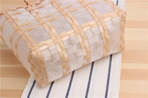 Macro shot of minimalist woven plastic basket bag with natural wood grain texture