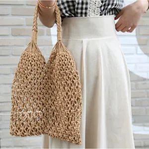 Detail view of khaki hand-woven mesh tote bag featuring artisanal diamond weave patterns