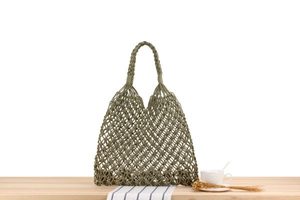 Detailed close-up of olive green hand-woven mesh tote bag with thick braided handles