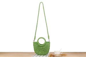 Detail of light green semi-circle woven bag showing handle and silver metal hooks