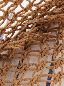 Handcrafted hollow mesh woven paper rope handbag in warm brown for an elegant forest style