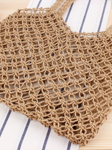 Handmade hollow woven paper rope handbag with hexagonal mesh and natural fiber texture