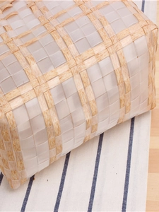 Minimalist checkered woven tote bag with beige striped patterns on a wooden table