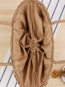 Natural paper straw woven handbag with drawstring fabric lining and top handles for beach vacations