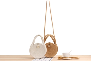 Close-up of circular woven cotton rope crossbody bags in beige and light brown