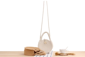 Detail of round woven cotton rope bags in cream and light brown for summer beach vacation