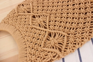 Detailed close-up of handmade khaki cotton rope weave showing the bohemian star knot pattern