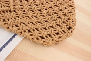 Close-up of hand-woven khaki cotton rope mesh showing intricate natural craft textures