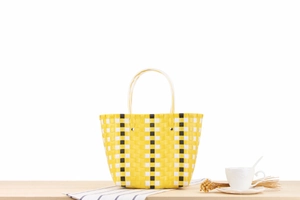 Macro shot of a colorful striped woven basket bag with waterproof plastic texture