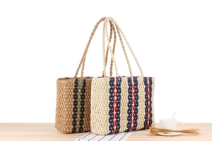 Detailed view of handmade paper rope woven shoulder bags with colorful vertical stripes
