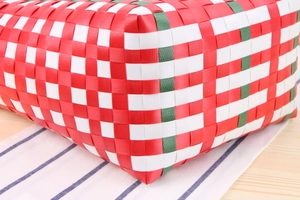 Macro shot of colorful checkered woven beach bag showing detailed base construction