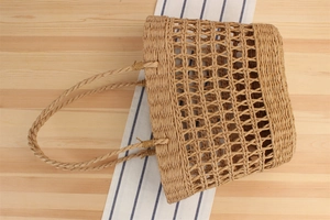 Detailed macro view of the hollow diamond pattern on a handmade paper rope woven tote bag
