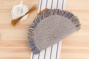 Detail of bohemian paper rope woven bag featuring vibrant blue fringe and wooden handle