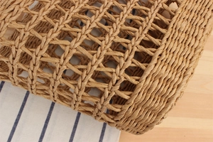 Detail of hand-woven paper rope shoulder bag featuring a hollow diamond grid pattern