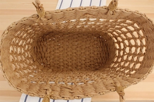 Top-down macro view of natural paper rope woven tote bag with intricate mesh pattern