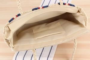 Detail view of woven beach tote showing textile lining, inner pocket, and zipper closure