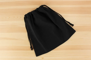 Macro view of black canvas drawstring inner bag with durable woven fabric texture