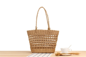 Detail view of the intricate hollow-out pattern on this handmade paper rope woven bag