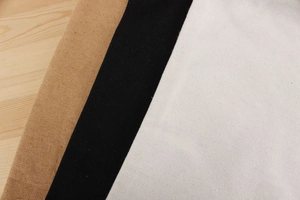 Detailed texture of canvas drawstring bag liners in brown, black, and beige colors