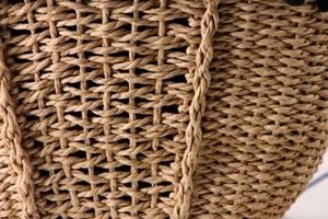 Detailed macro view of high-quality hand-woven paper rope texture on summer beach bag