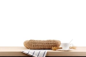 Detail of hand-woven paper rope bag showing natural brown texture on a wooden table