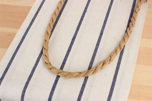 Close-up of brown paper rope woven strap texture with a natural handmade finish