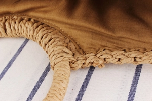Close-up of hand-woven texture and durable brown lining on this summer beach tote