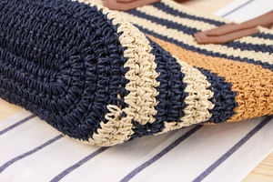 Detailed macro view of woven tote bag bottom showing striped pattern and knit craftsmanship