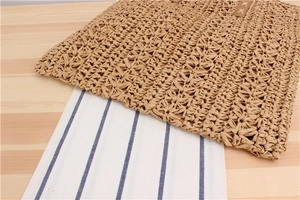 Close-up of handmade paper rope woven bag showing star-shaped texture and leather trim