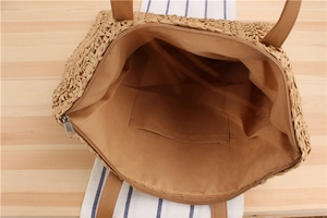 Top view of woven paper rope tote bag showing brown fabric lining and inner pocket