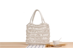 Detailed view of handmade macrame cotton rope tote bag with bohemian woven mesh pattern