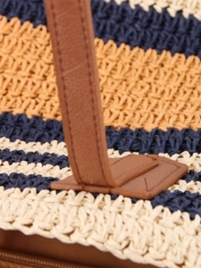 Striped woven straw tote bag with brown leather handles and sturdy reinforced stitching