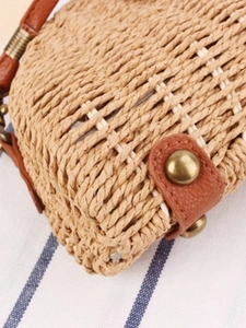 Handmade semi-circle straw woven beach bag with brown leather trim and brass rivets