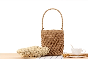 Detail view of handmade paper rope bucket bag with textured bobble stitch and handles