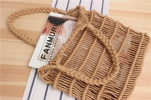 Detailed view of handmade khaki cotton rope woven tote bag on a wooden surface