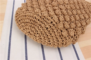 Close-up of popcorn stitch texture on natural paper rope woven cylinder bucket bag