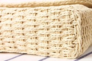 Macro shot showing the intricate hand-woven texture and natural fiber of the crossbody bag