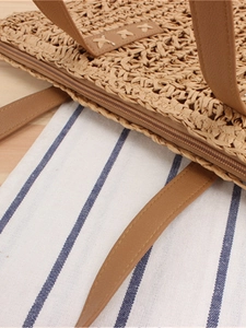 Handwoven straw shoulder bag with light brown paper rope texture and zipper closure