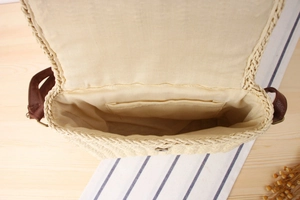 Detail view of the hand-woven crossbody bag with inner lining and magnetic snap closure