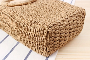 Close-up of the thick paper rope weaving texture and base of the summer beach bag