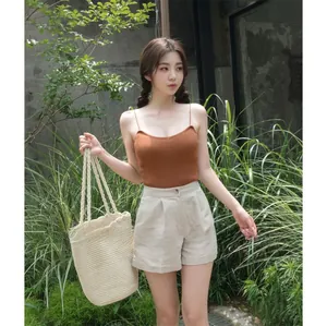 Outdoor view of a woman carrying a handmade woven cotton rope beach shoulder bag