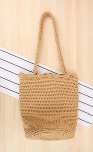 Close-up of hand-woven cotton rope bucket bag with decorative scallop edge and sturdy handles
