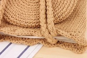 Detail view of khaki hand-woven cotton rope bag with wavy edges and linen lining