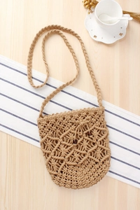 Detailed close-up of handmade macrame crossbody bag with dark wood bead accents