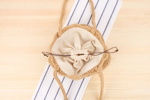 Detail of hand-woven cotton rope beach bag showing drawstring lining and internal space