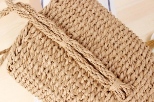 Detailed view of the paper rope woven bucket bag showing natural texture and handle knot